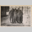 Three men standing outside stone building (ddr-densho-466-294)