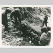 Servicepeople transporting soldier on stretcher (ddr-densho-1007-160)