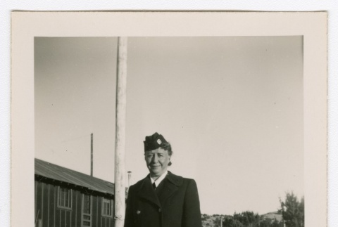 Henrietta Schoen posing in front of barracks (ddr-densho-223-9)