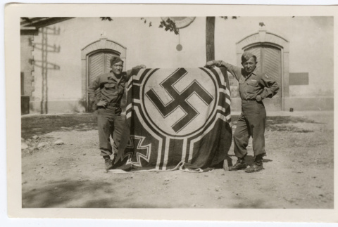 Tom Inouye and Bill Teragawa pose with a Nazi flag (ddr-densho-451-17)