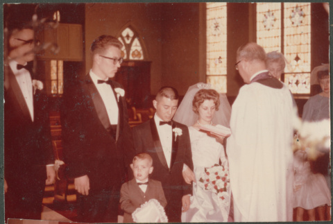 Bride and Groom kneeling with minister (ddr-densho-523-378)