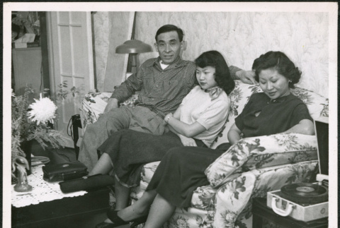 Two women and a man sitting on sofa (ddr-densho-293-180)