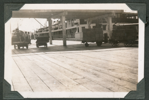 Boardwalk with boat docked in background (ddr-densho-540-62)