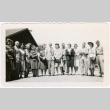 Group of 15 people standing, several men and women in uniform (ddr-ajah-2-11)