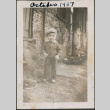 Toddler in sweater and hat standing on dirt street (ddr-densho-483-697)