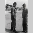 Two men in fatigues standing on beach (ddr-densho-474-240)