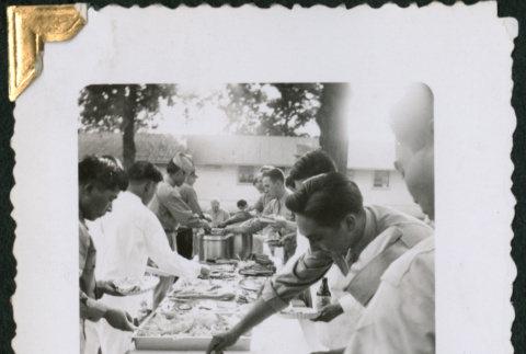 Men at food table (ddr-densho-434-288)
