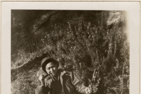 Man with rifle smoking a pipe (ddr-densho-466-296)