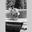Marsha Miyamoto being thrown in the lake (ddr-densho-336-581)