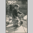 Boy on scooter (ddr-densho-523-119)