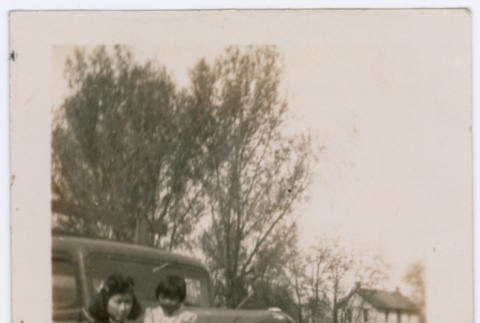Sisters pose with car (ddr-densho-363-7)