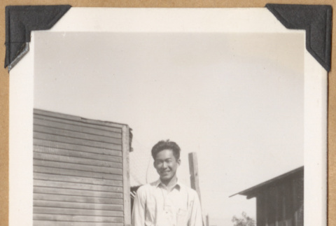Gary Kikawa on a grassy lawn (ddr-densho-542-157)