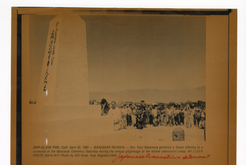 Crowd stands near a memorial monument at Manzanar (ddr-csujad-52-17)