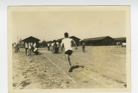 Man running on dirt track (ddr-csujad-44-13)