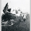 522nd soldier kneeling next to downed German planes (ddr-densho-22-109)