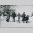 Sakura family standing in snow holding hands (ddr-densho-523-234)