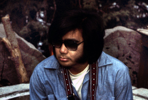 Robert Hanashiro holding a camera (ddr-densho-336-331)