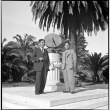 Two men standing by sun dial (ddr-densho-426-1636)
