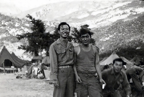 Three men in fatigues standing by tents (ddr-densho-474-232)