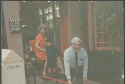 Chester Sakura pulling Agnes and grandson on rickshaw (ddr-densho-523-465)