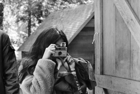 Camper taking a photograph with a Kodak Instamatic (ddr-densho-336-240)