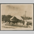 Photo of people gathered under a canvas tent (ddr-densho-483-928)