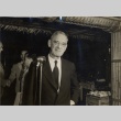 Charles Reed Hemenway posing with a microphone, while Walter Dillingham shakes hands with Varsity Victory Volunteers members (ddr-njpa-2-395)
