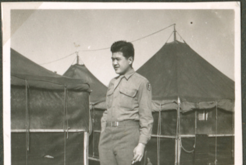 Soldier in front of tents (ddr-densho-201-515)