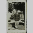 A man standing in front of a house (ddr-densho-328-569)