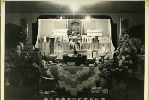 Altar with offerings at the Manzanar Buddhist Church (ddr-manz-4-58)
