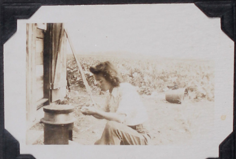 Woman lighting a small stove (ddr-densho-467-27)