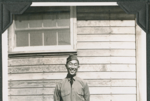 Joe Iwataki in uniform standing outside building (ddr-ajah-2-153)