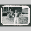 Shirtless man stands outside building (ddr-densho-471-109)