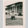 Man crouching outside Poston General Hospital (ddr-densho-475-444)