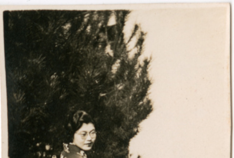 Tomoye (Nozawa) Takahashi in kimono standing by tree (ddr-densho-426-2148)