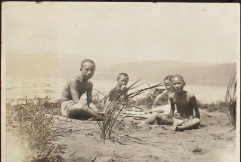 Children sitting on the beach (ddr-densho-278-74)