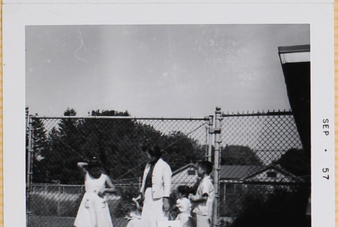 Yoshiko, William, Susan and Leslie Shiomi with unidentified girl standing by fence (ddr-densho-522-413)