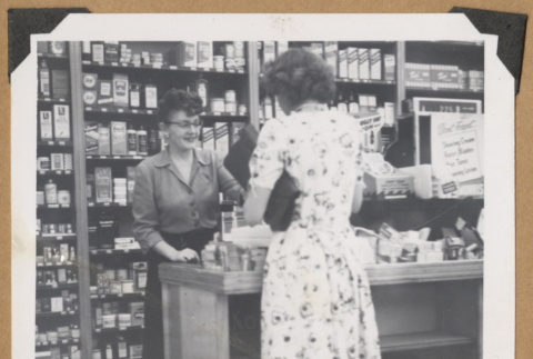 Woman helping a customer (ddr-densho-542-125)
