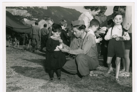 George Morihiro of Company I with an Italian orphan at a 4th of July party (ddr-densho-1007-414)