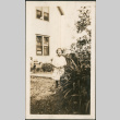 Girl in garden outside house (ddr-densho-293-44)