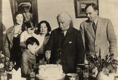 David Lloyd George cutting cake with a family (ddr-njpa-1-1202)