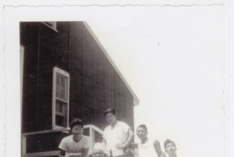Seven men on steps outside barrack (ddr-densho-471-7)