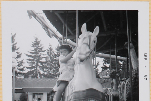Leslie Shiomi on Merry-go-round (ddr-densho-522-421)