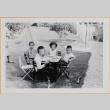 Four children sitting a table in a yard (ddr-densho-522-406)