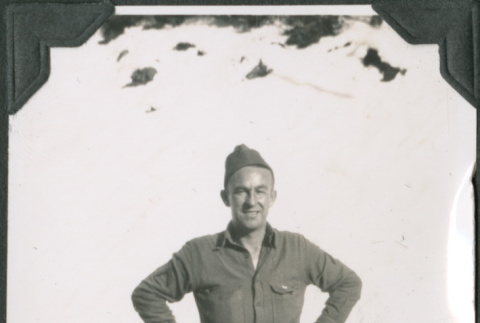 Man in uniform standing by pile of snow (ddr-ajah-2-275)