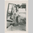 Man holding two fish on dock (ddr-densho-326-17)