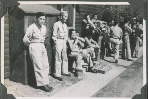 Group of men lined up outside building (ddr-ajah-2-503)
