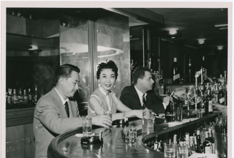 Mary Mon Toy sitting at a bar with two men (ddr-densho-367-112)