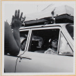 Woman waving to group in car (ddr-densho-522-102)