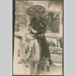 Chester Sakura Sr sitting on donkey in Nogales Mexico (ddr-densho-523-433)